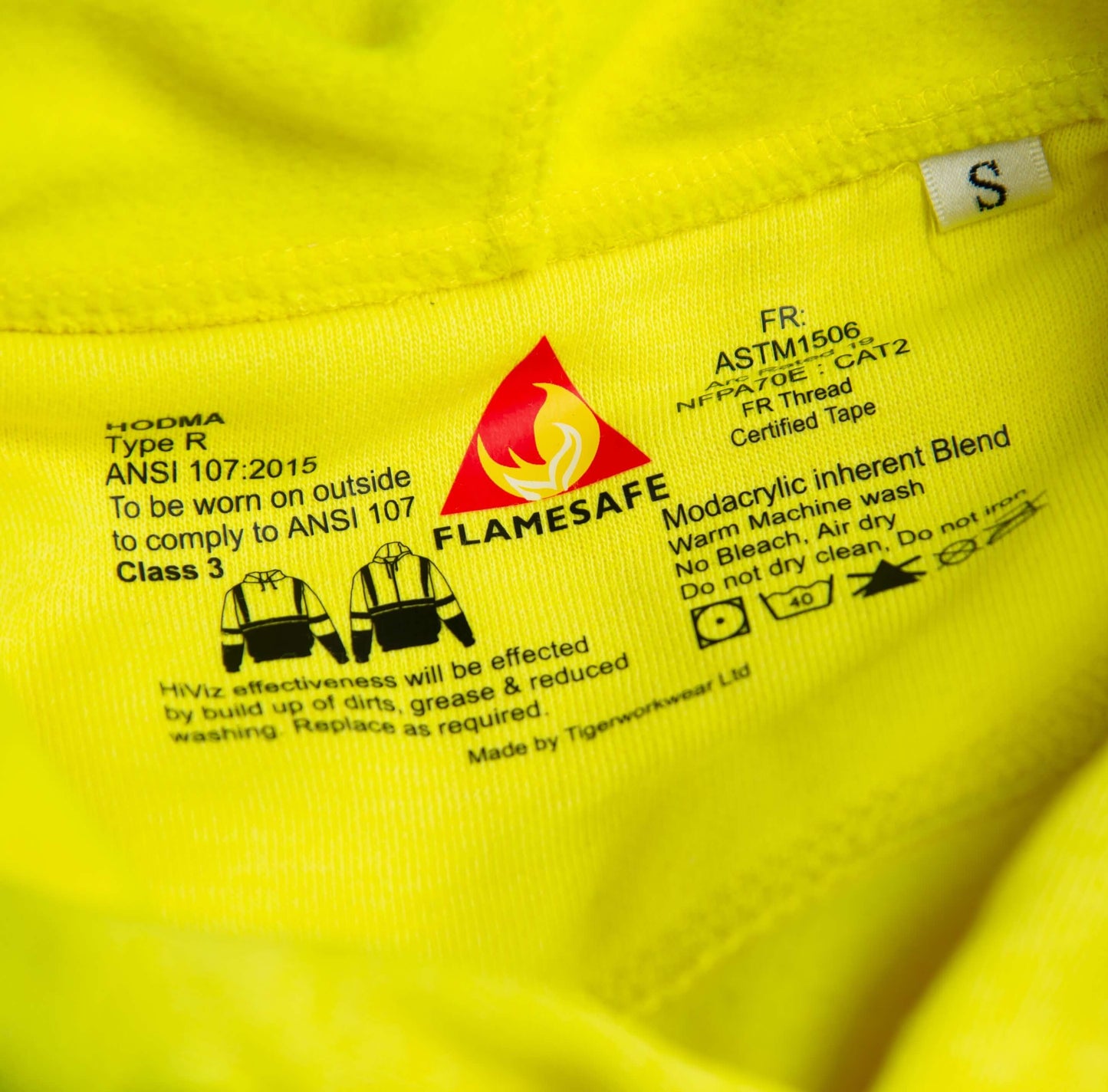 Close-up image of a yellow fabric label with safety and care instructions.